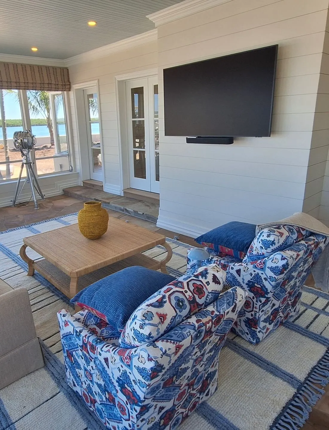 Sunroom with a wall-mounted Samsung TV over the water