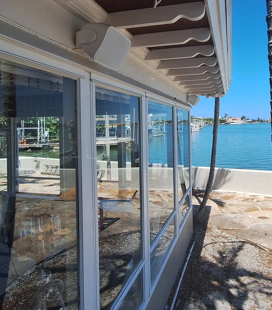 Outdoor speaker under the eave, facing the bay